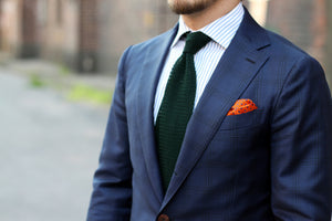 Blue suit with green knitted tie
