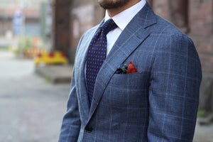 Printed silk tie with a gray suit
